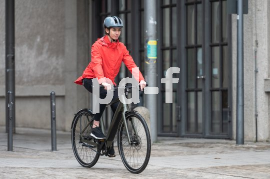 Eine Frau fährt ein E-Bike in der Stadt.