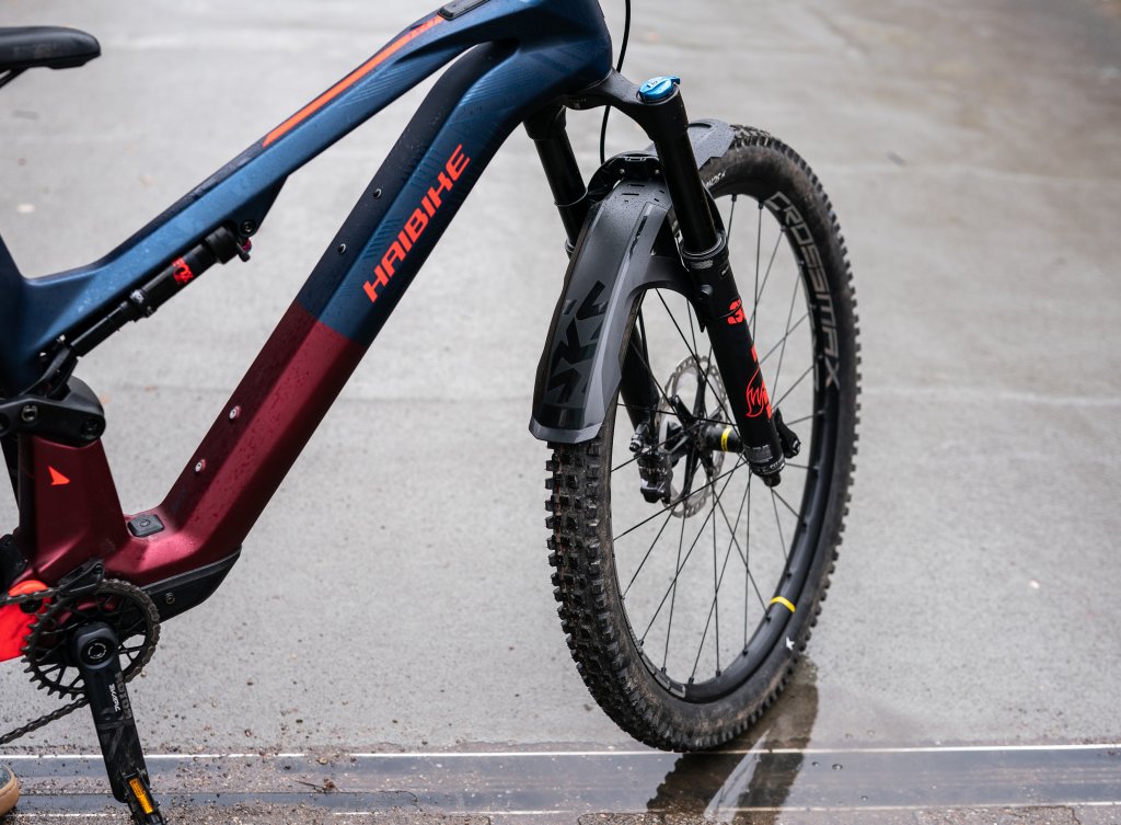 E-Mountainbike steht auf einer nassen Fläche.