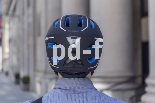 Rückansicht eines Fahrradhelmes auf dem Kopf einer Person.
