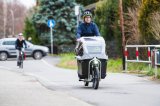 Mann fährt mit Cargobike auf Radweg